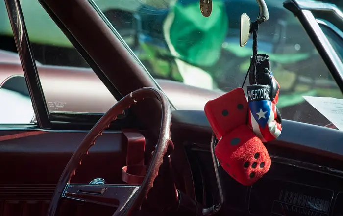Fuzzy Dice and Puerto Rican Boxing Gloves hanging from Mirror (54188936131)