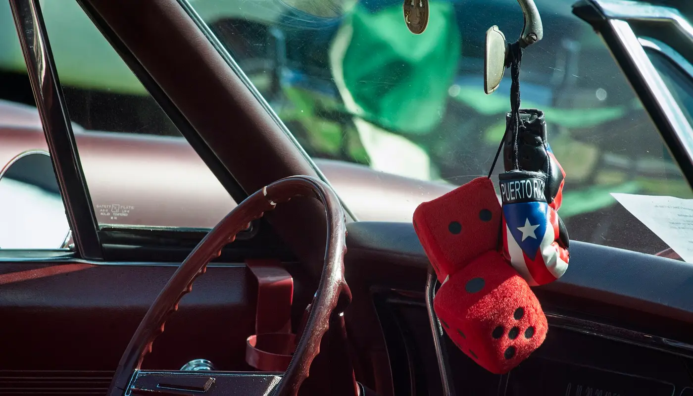 Fuzzy Dice and Puerto Rican Boxing Gloves hanging from Mirror (54188936131)